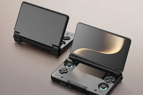 Two AYN Thor dual-screen clamshell handhelds, one open